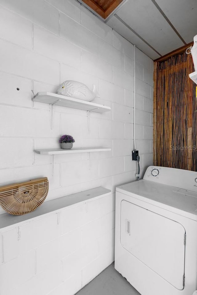 laundry room with washer / dryer and concrete block wall