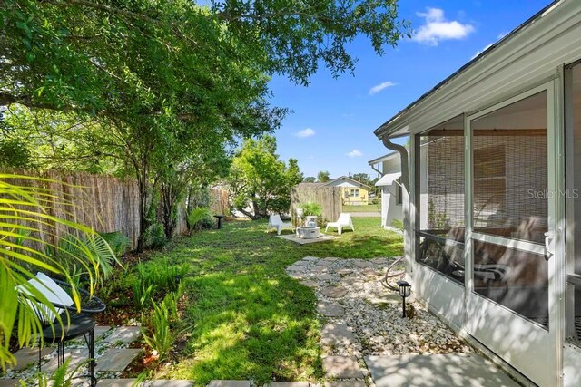 view of yard featuring fence, a patio, and a fire pit