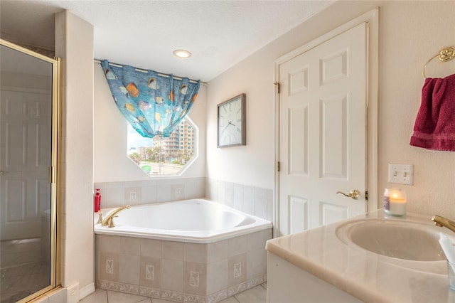 full bathroom with tile patterned floors, a stall shower, a bath, and vanity