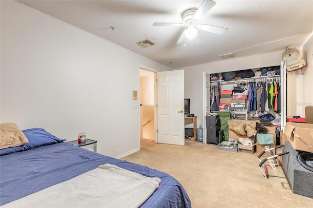 carpeted bedroom with visible vents, ceiling fan, and a closet