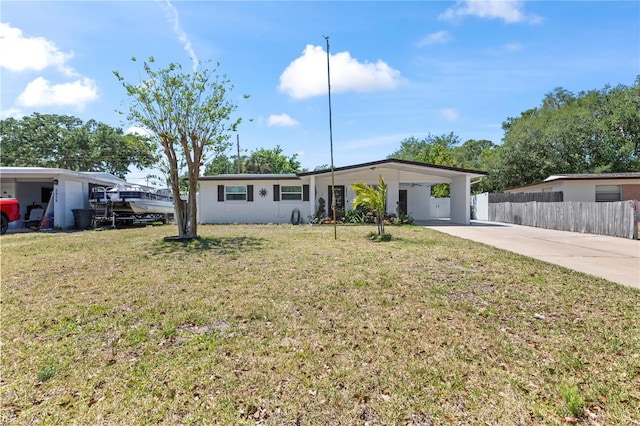2824 Oak Lea Dr, South Daytona, FL 32119 - ranch-style house with concrete driveway, fence, a front yard, and an attached carport