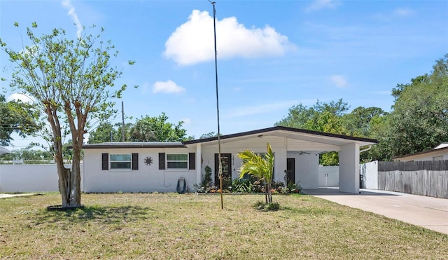 2824 Oak Lea Dr, South Daytona, FL 32119 - ranch-style house featuring fence, a carport, concrete driveway, and a front lawn