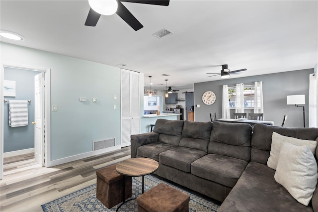 2824 Oak Lea Dr, South Daytona, FL 32119 - living room featuring a ceiling fan, visible vents, and light wood finished floors