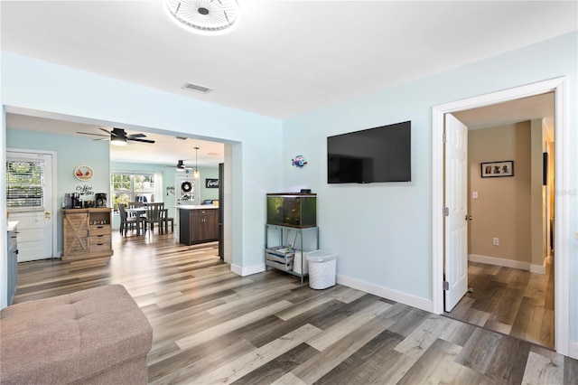 2824 Oak Lea Dr, South Daytona, FL 32119 - living room featuring baseboards, ceiling fan, light wood-type flooring, and visible vents