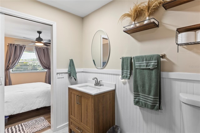 2824 Oak Lea Dr, South Daytona, FL 32119 - bathroom featuring ceiling fan, wainscoting, vanity, toilet, and ensuite bathroom