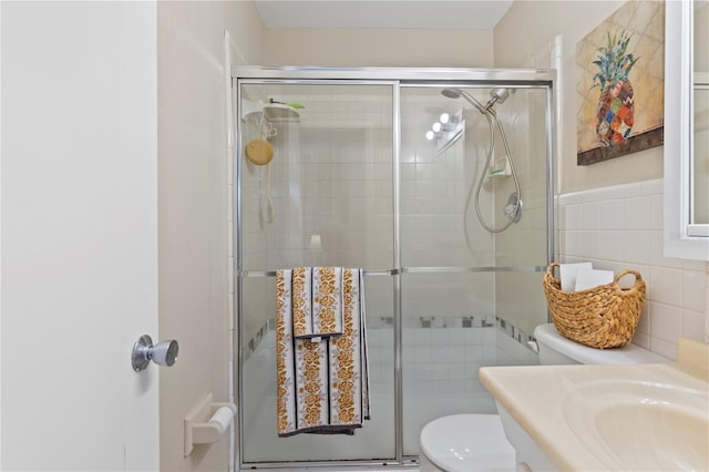 2824 Oak Lea Dr, South Daytona, FL 32119 - bathroom featuring vanity, a stall shower, toilet, and tile walls