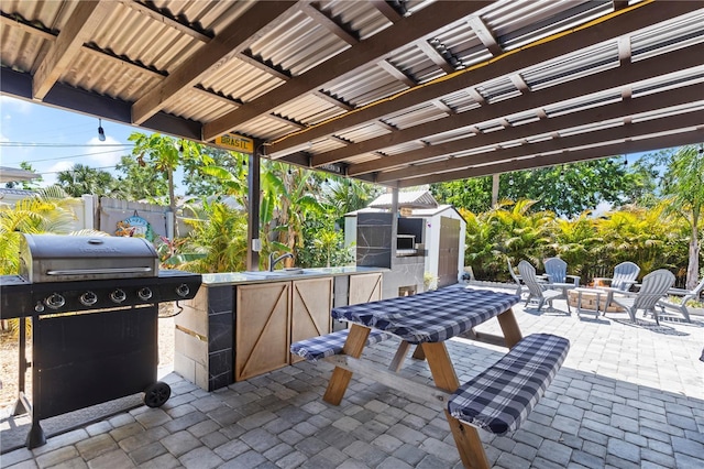 2824 Oak Lea Dr, South Daytona, FL 32119 - view of patio with fence, a storage shed, an outbuilding, a sink, and a grill