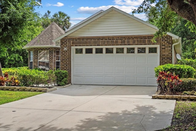 30 Reflections Village Dr, Ormond Beach, FL 32174 - view of front of house featuring an attached garage, concrete driveway, and brick siding