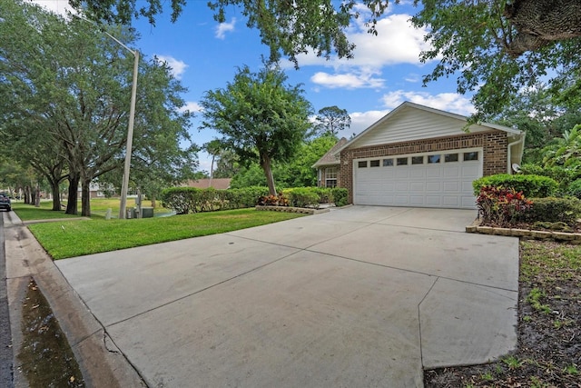 30 Reflections Village Dr, Ormond Beach, FL 32174 - view of front of house featuring concrete driveway, brick siding, an attached garage, and a front yard