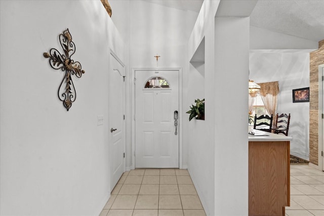 30 Reflections Village Dr, Ormond Beach, FL 32174 - hall featuring baseboards, lofted ceiling, and light tile patterned floors