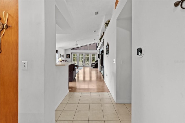30 Reflections Village Dr, Ormond Beach, FL 32174 - hallway with baseboards, vaulted ceiling, and light tile patterned floors
