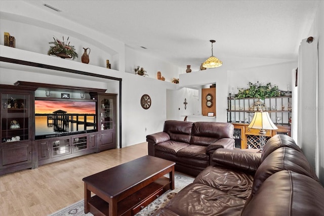 30 Reflections Village Dr, Ormond Beach, FL 32174 - living room featuring visible vents, wood finished floors, and lofted ceiling