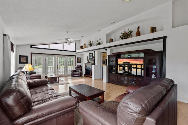 30 Reflections Village Dr, Ormond Beach, FL 32174 - living area with a ceiling fan, a textured ceiling, wood finished floors, and vaulted ceiling