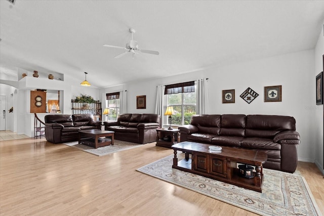 30 Reflections Village Dr, Ormond Beach, FL 32174 - living room with arched walkways, ceiling fan, vaulted ceiling, and light wood-style floors