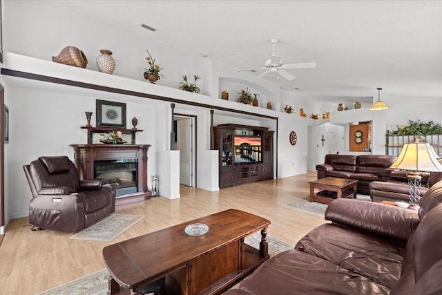 30 Reflections Village Dr, Ormond Beach, FL 32174 - living room featuring a glass covered fireplace, ceiling fan, wood finished floors, and visible vents