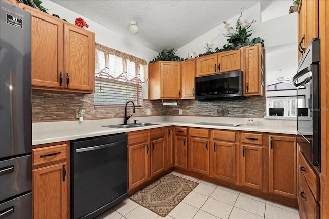 30 Reflections Village Dr, Ormond Beach, FL 32174 - kitchen with backsplash, a sink, black appliances, and light countertops