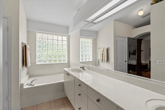 30 Reflections Village Dr, Ormond Beach, FL 32174 - full bath featuring a garden tub, double vanity, tile patterned flooring, visible vents, and a sink