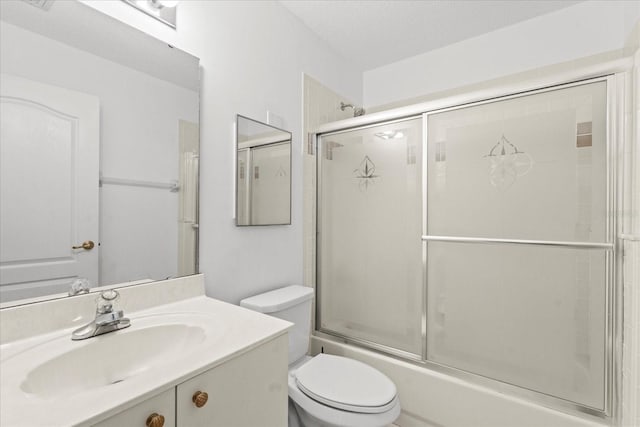 30 Reflections Village Dr, Ormond Beach, FL 32174 - bathroom featuring vanity, bath / shower combo with glass door, and toilet