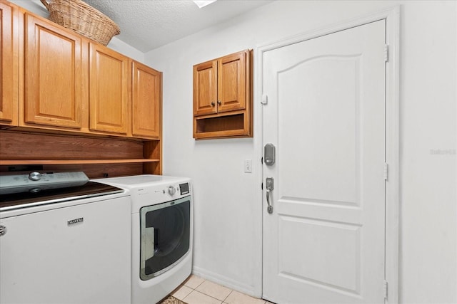 30 Reflections Village Dr, Ormond Beach, FL 32174 - laundry room featuring cabinet space, light tile patterned flooring, a textured ceiling, and washer and dryer