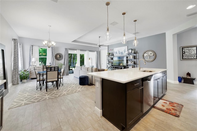 kitchen with dark brown cabinetry, a sink, light wood-style floors, light countertops, and dishwasher