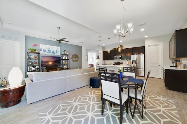 dining space featuring recessed lighting, visible vents, ceiling fan with notable chandelier, and light wood-style floors