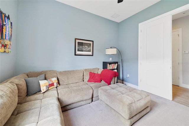 living area featuring baseboards and carpet floors