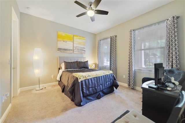 carpeted bedroom featuring baseboards and ceiling fan