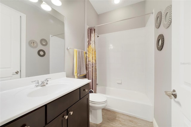 full bath featuring vanity, shower / bathtub combination with curtain, wood finished floors, and toilet