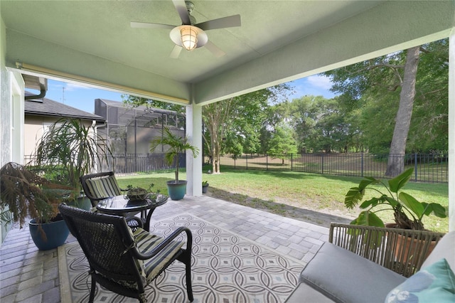 sunroom / solarium with a ceiling fan
