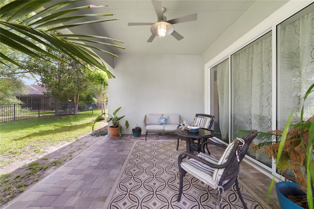 view of patio / terrace featuring fence, ceiling fan, and outdoor lounge area