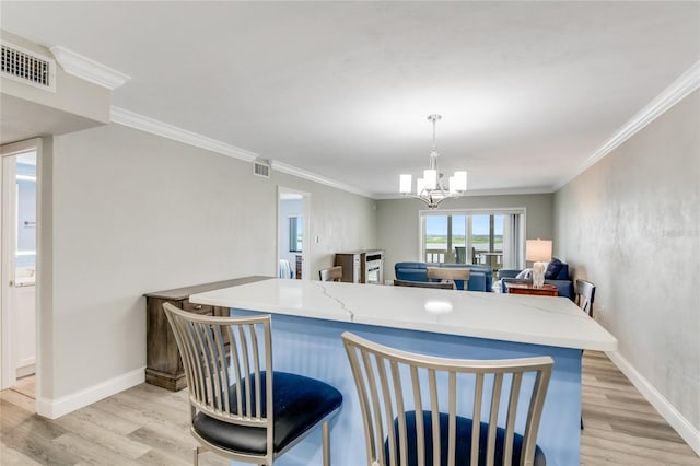kitchen featuring an inviting chandelier, light wood finished floors, and visible vents