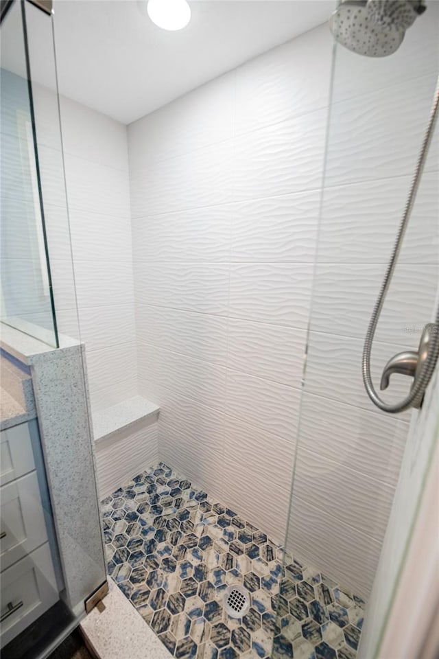 full bath with a tile shower