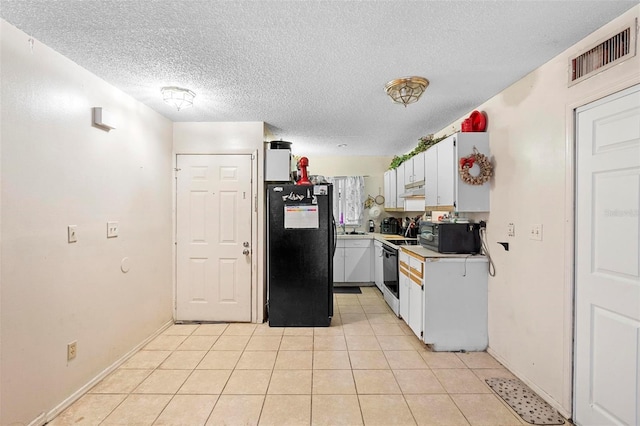 313 Dirksen Dr Unit A5, Debary, FL 32713 - kitchen featuring black appliances, light countertops, a textured ceiling, white cabinetry, and light tile patterned flooring