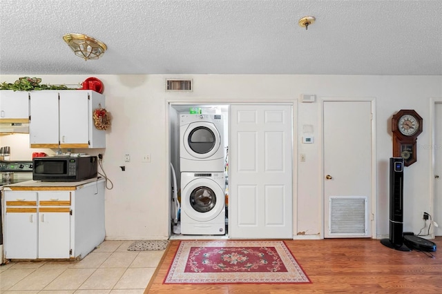 313 Dirksen Dr Unit A5, Debary, FL 32713 - clothes washing area with stacked washer / drying machine and a textured ceiling