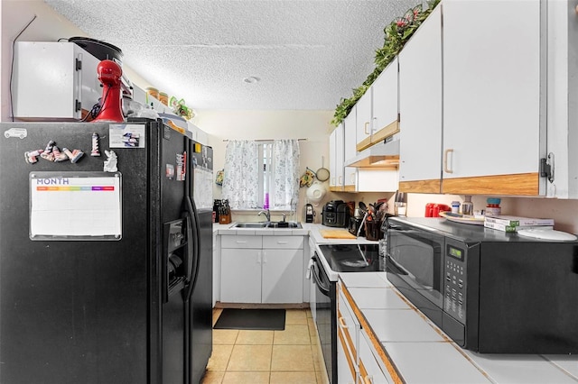 313 Dirksen Dr Unit A5, Debary, FL 32713 - kitchen featuring black appliances, under cabinet range hood, a sink, tile countertops, and a textured ceiling