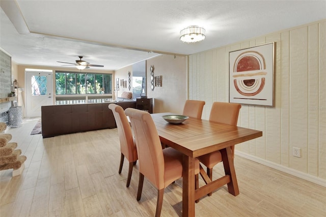 dining space featuring ceiling fan and light wood-style floors