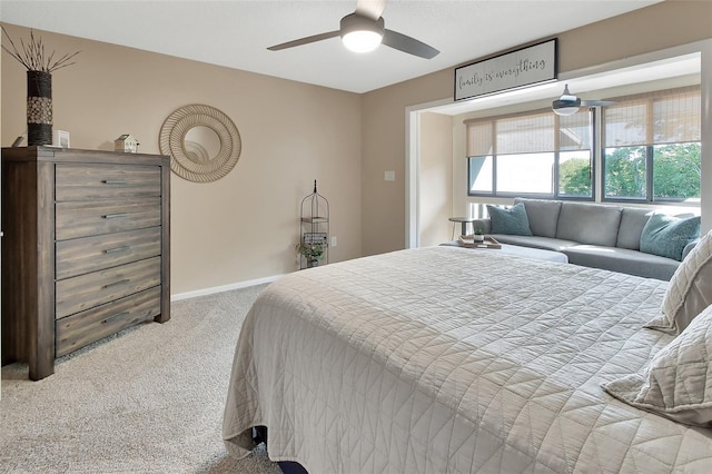 carpeted bedroom featuring baseboards and a ceiling fan