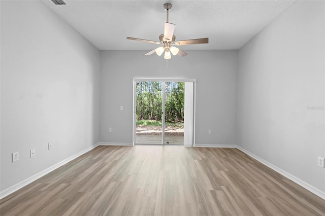 15733 Green Point Ct, Clermont, FL 34714 - empty room featuring a ceiling fan, light wood-style floors, a textured ceiling, and baseboards