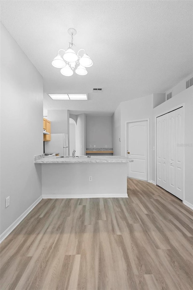 15733 Green Point Ct, Clermont, FL 34714 - unfurnished living room with light wood-type flooring, a chandelier, and visible vents