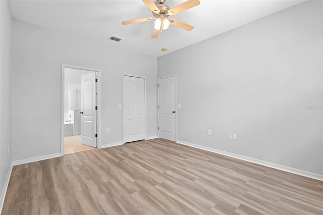 15733 Green Point Ct, Clermont, FL 34714 - unfurnished bedroom with a closet, baseboards, ensuite bathroom, visible vents, and light wood-type flooring