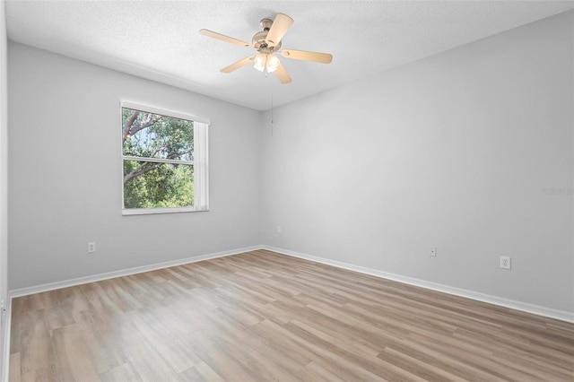 15733 Green Point Ct, Clermont, FL 34714 - unfurnished room with baseboards, a textured ceiling, light wood-style floors, and a ceiling fan