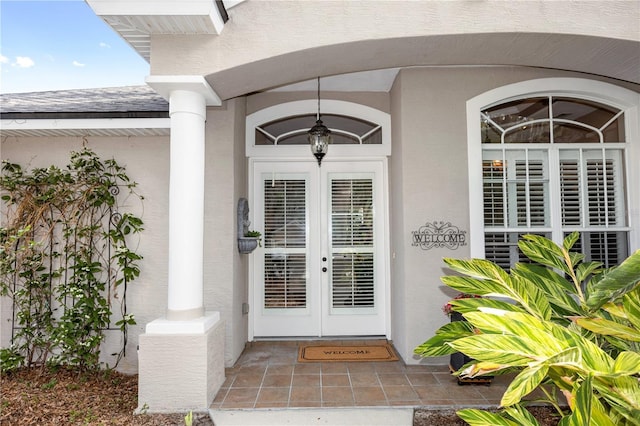 property entrance with french doors and stucco siding