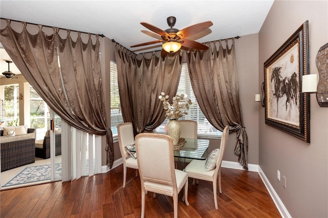 dining room featuring a ceiling fan, baseboards, and wood finished floors