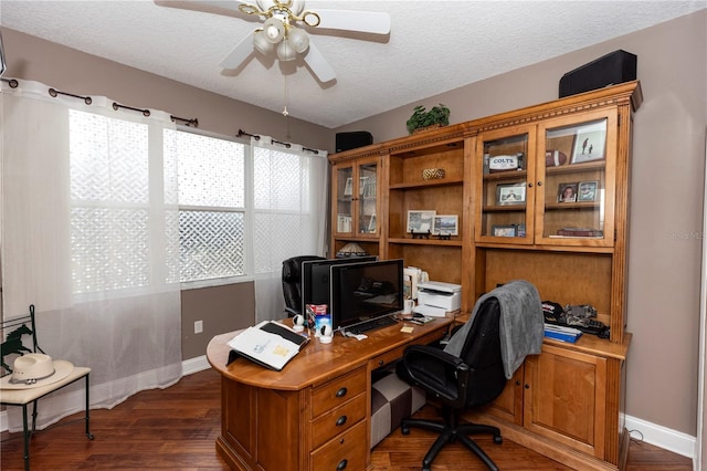 home office with baseboards, ceiling fan, dark wood-style flooring, and a textured ceiling
