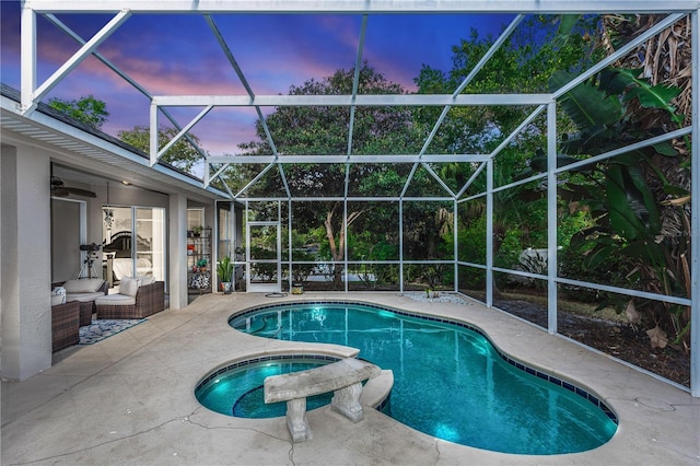 view of swimming pool with a pool with connected hot tub, a lanai, and a patio area
