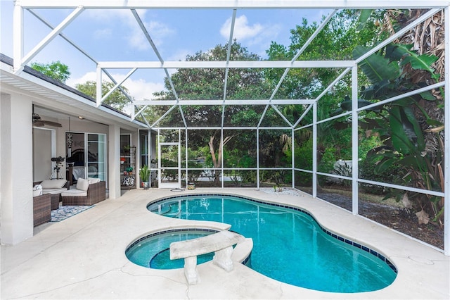 pool featuring outdoor lounge area, a patio, a ceiling fan, an in ground hot tub, and a lanai
