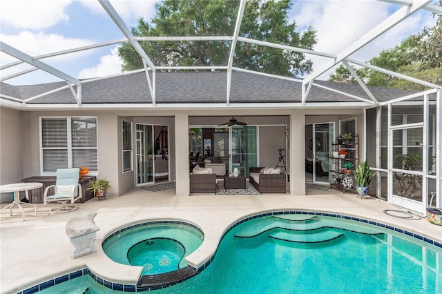 rear view of property with a patio, a shingled roof, stucco siding, and an outdoor hangout area