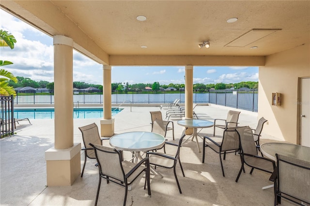 view of patio with a fenced in pool and fence