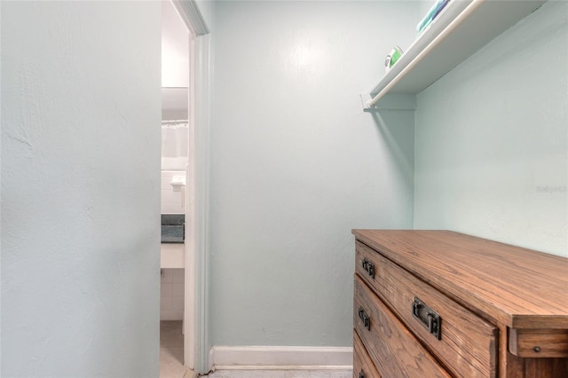 spacious closet with light tile patterned flooring