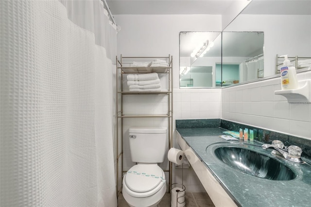 bathroom with tile patterned flooring, vanity, toilet, tile walls, and tasteful backsplash
